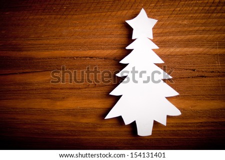 Christmas tree cut out from paper on a wooden background