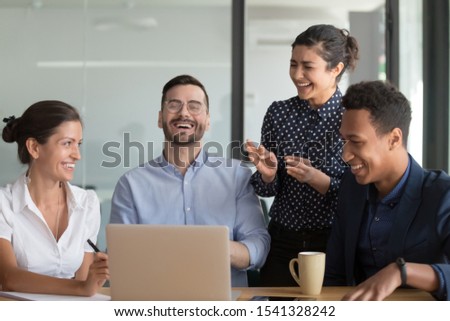 Happy black, indian and caucasian diverse female and male colleagues enjoying positive emotions. Multiracial managers group having fun at break or during business meeting in board room at work