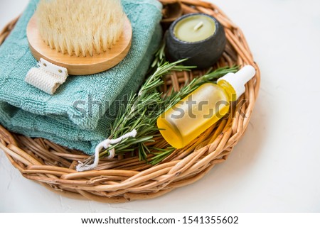 Clean beauty. Natural spa products with rosemary herb and oil, candle, towel and brush, natural home skincare products, homespa and wellness clean beauty products