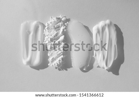 Smears of different beauty product. Moisturizer cream, translucent loose powder, soap, facial mask and cleanser isolated on white background. Beauty and face, hand and body skin care concept