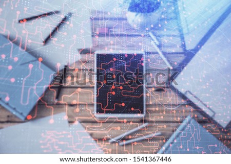 Double exposure of technology theme drawing on digital tablet laying on table background. Concept of hightech