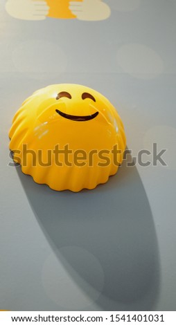 Beautiful yellow emoji emoticons on a wall