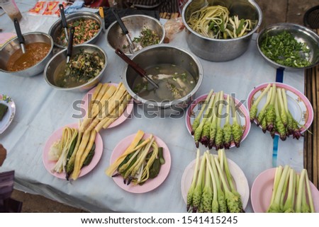 typical thai food and fruits, seen at a market in isan thailand.