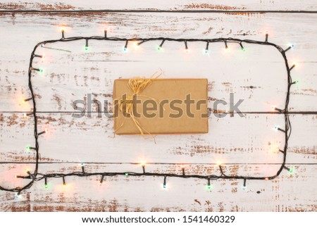 One gift surrounded with Christmas lights 