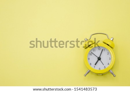 View above the yellow clock on the yellow background.