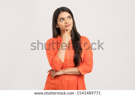 Pretty Indian girl thinking on white.