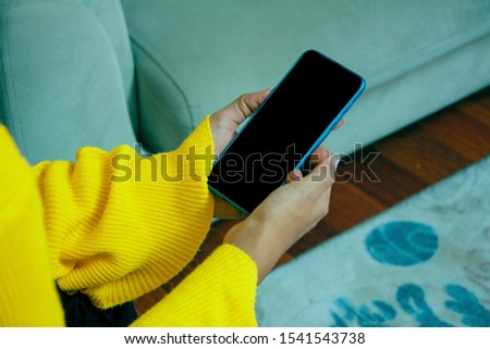 Young woman holding phone in hand