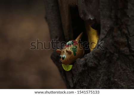 background with a mouse watching from a hole in a tree