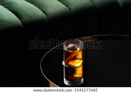 Fresh cocktail glass on glass table in night club restaurant. Alcohol cocktail drink, close-up. Retro alcoholic beverage Royalty-Free Stock Photo #1541577605