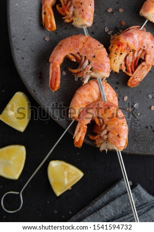 Grilled shrimps overhead shot on dark table