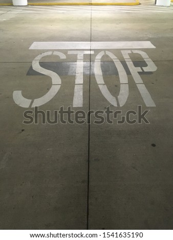 Stop sign in the parking garage floor