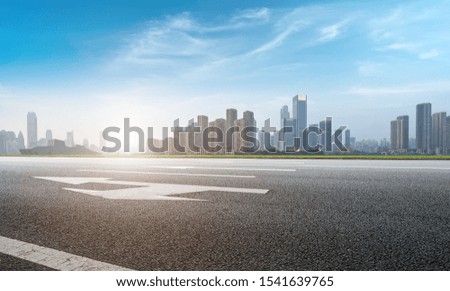 Empty asphalt road along modern commercial buildings in Chinese 