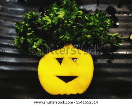 Yellow pumpkin with green vegetable hair for this Halloween 