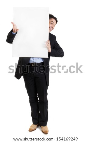 Businessman with a blank white sign peering around the side with a smile.