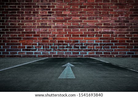 White Arrow on the Road Straight to the Old Brick Wall Background, Suitable for Business Dead End Concept. Royalty-Free Stock Photo #1541693840