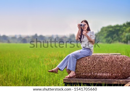 Asian women travel in nature with camera taking photo for Social media 