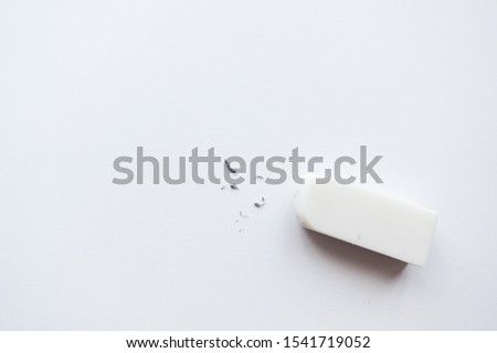 White eraser scrap on paper background. Error Eraser dust on white background. top view.           Royalty-Free Stock Photo #1541719052