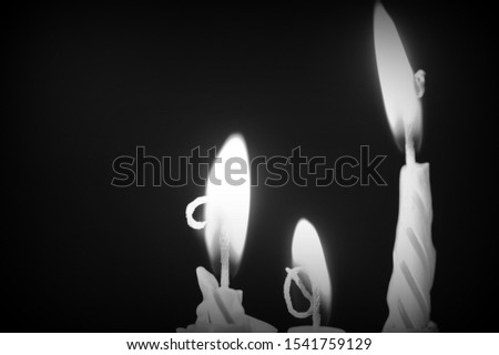Birthday candles against a dark background close-up. Black and white