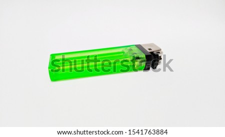 Green Gas Lighter on White Background. Clear Green Plastic Gas Lighter
