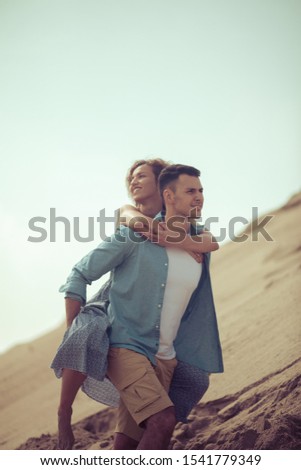  They are happy together. Couple on sand.