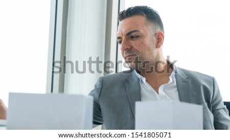businessman sit and thinking about work with the model and material on the desk.
