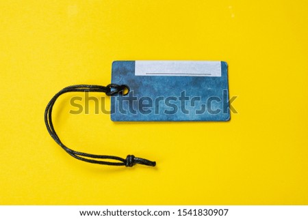 cardboard label with a string. without inscriptions. on a yellow background. place for text
