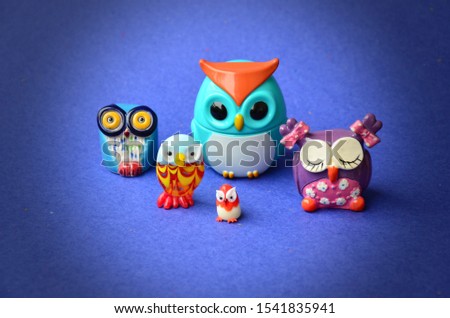 Collection of colorful owls on the blue background