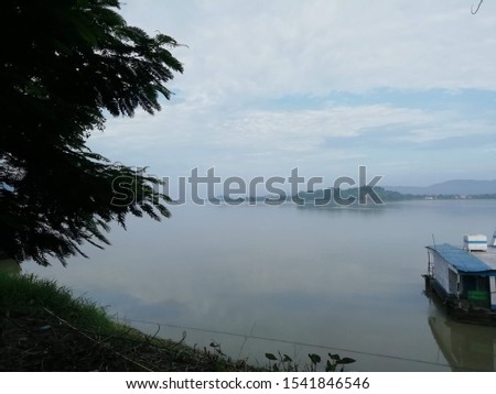 Brahmaputra river in assam with the view of Lord shiva temple on the island seen afar in the picture. The picture is taken in the early morning light. 