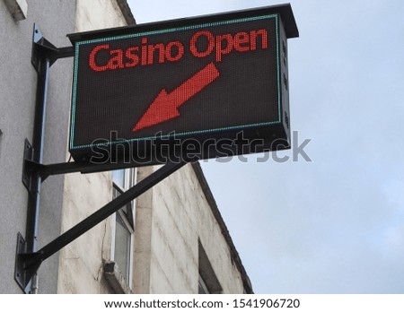 Casino Open neon outside wall sign with directional arrow. 