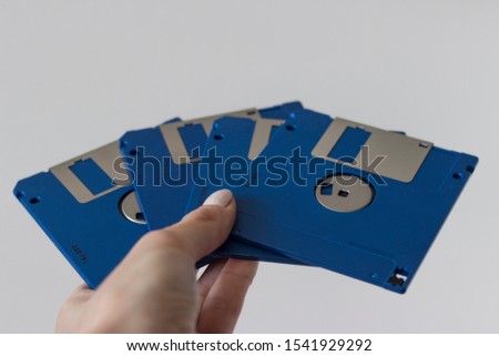 Holding Blue Floppy A disks isolated on white background.
Disk storage 