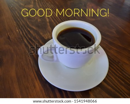 A cup of Americano coffee isolated on a wooden table for Good Morning.