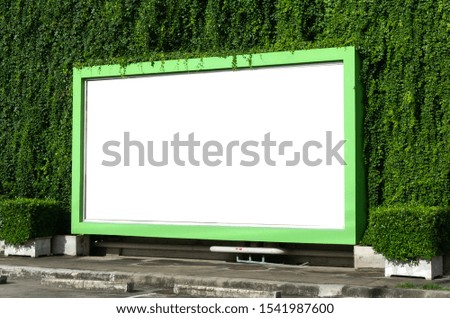 White billboard on spring summer green leaves background.