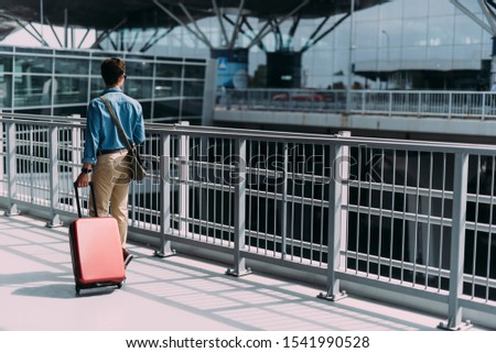 Man is carrying baggage while going on flight. Website banner