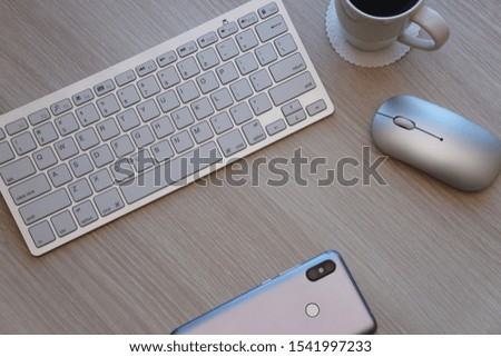White Keyboard with mouse on office desk with mobile phone and coffee                              
