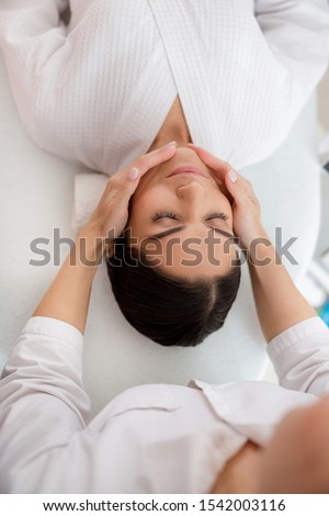Masseuse hands massaging lady face stock photo