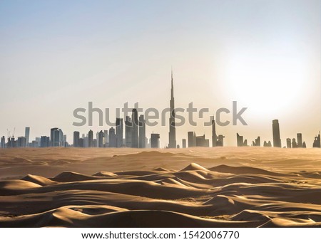 Dubai skyline in the desert at sunset. United Arab Emirates.