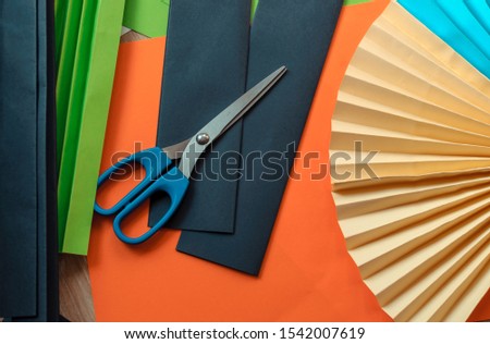 sheets of colored paper, scissors, blanks for origami. blanks for paper fan. Template for design, advertisement or text.