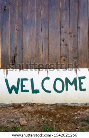 Welcome sign on the wall of the house
