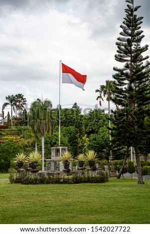 Raised flag of Indonesia in outdoor park