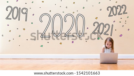 2020 with little girl using a laptop computer on floor