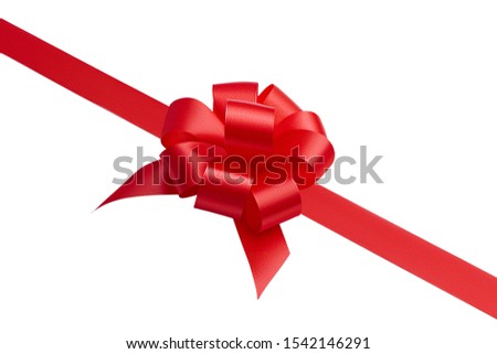 Side view of a large beautiful gift fashionable handmade creative bow and red satin ribbon located diagonally on a picture isolated on white background
