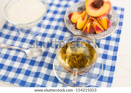 Breakfast. Green tea, youghurt and peach
