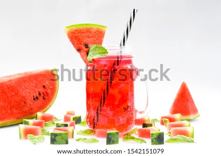 Red fresh watermelon juice with sliced ​​watermelon and mint  Delicious on the white background, close-up