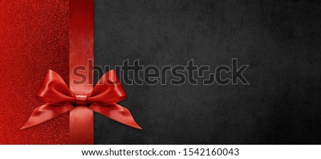 gift card wishes merry christmas background with red ribbon bow on black shiny vibrant color texture template with blank copy space