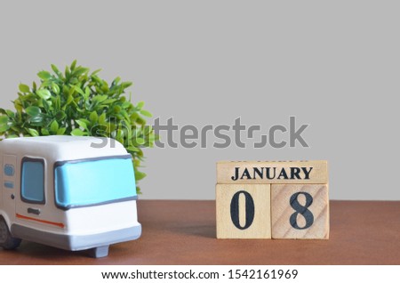 January cover design with number cube and car, Date 8.