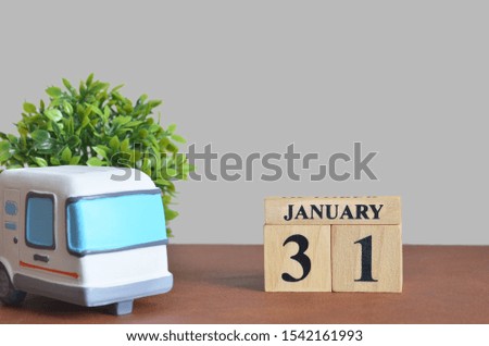 January cover design with number cube and car, Date 31.