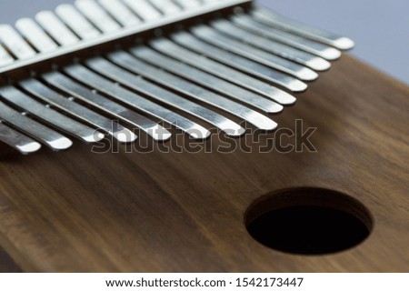 Metal keys of a wooden musical instrument kalimba close-up