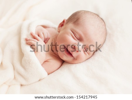 Smiling newborn baby 6 days old Royalty-Free Stock Photo #154217945