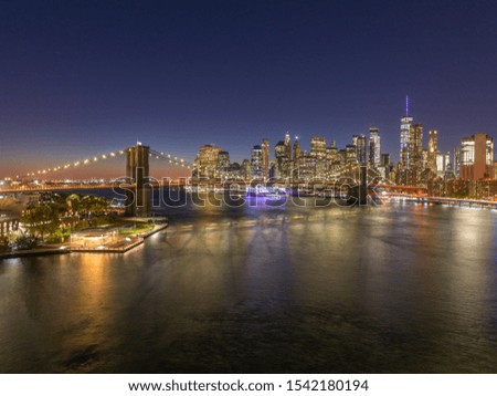 New York City downtown buildings skyline Brooklyn Bridge night evening