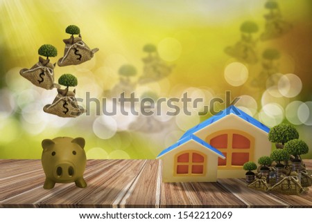 Hemp bag with dollar sign and growing tree,with dropping from top, wooden house and piggy bank,concept saving money,investment and financial planning,deposit in bank,real estate investment,and fund